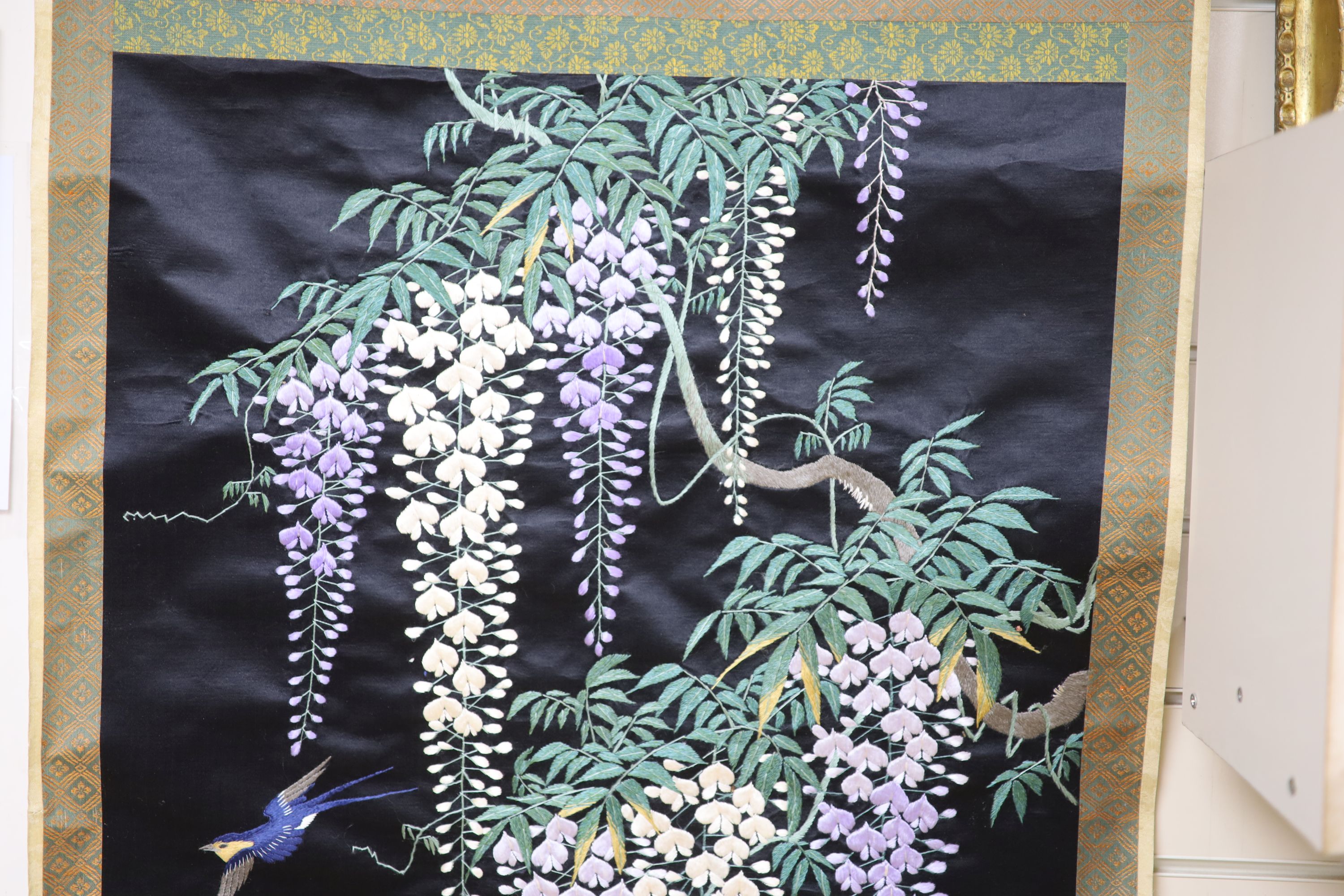 A Japanese embroidered wisteria hanging scroll, overall length 170cm